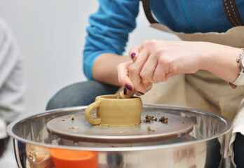 A man working on a potter's wheel. Creative work with clay.