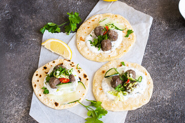 Lamb meatballs with pita bread and white spicy sauce. Top view. - 484712659