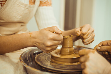 A man working on a potter's wheel. Creative work with clay.