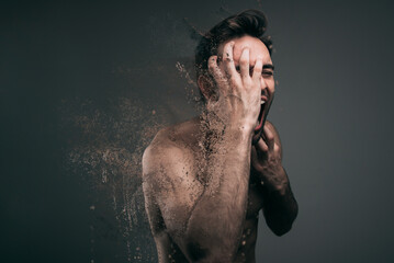 Screaming frustrated man exploding and disintegrating into particles, agonizing and torturing...