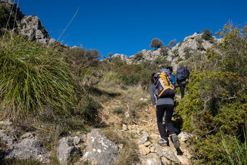 hikers ascending Cucuia de Fartaritx, Assarell , Pollença, Mallorca, Balearic Islands, Spain