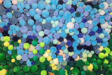 
The wall is made of balls of multi-colored threads as a background
