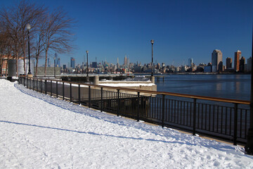 Midtown Manhattan and the Empire State Building with the snow from Hudson River Walkaway