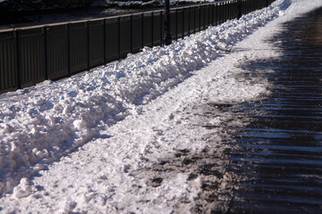 The fresh snow on the wooden walkaway in a sunny winter day