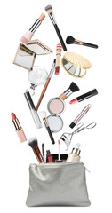 Different makeup products falling into stylish cosmetic bag on white background