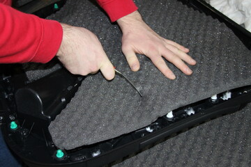 The master installs sound insulation material on the inside of the car door card. The process of...