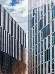 Fototapeta na wymiar Modern glass office building against the clear blue sky. Abstract photography