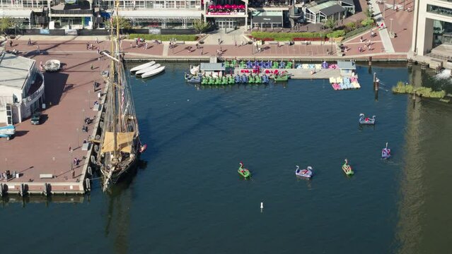 Aerial Shot Of Animal Shaped Boats Moving In River, Drone Flying On Sunny Day - Baltimore, Maryland