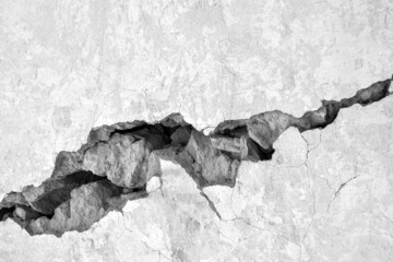 Big crack on gray wall, abstract image of the horizontal cleft. Wide and deep fault. Black and...
