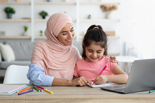 Doing Homework Together. Loving Muslim Mom Helping Her Little Daughter With Study