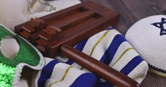 Purim Jewish celebration carnival on hamantaschen cookies, noisemaker and mask