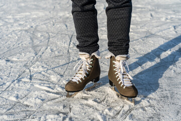 Women's figure skates on ice with a little bit snow