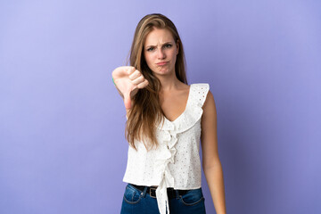 Young caucasian woman over isolated background showing thumb down with negative expression