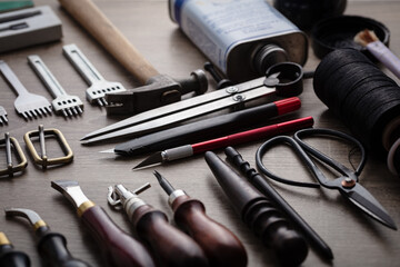 Concept of leather handcraft instruments.Instruments laying on a table