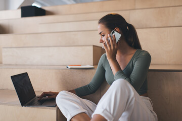 European girl working on wooden bench in office