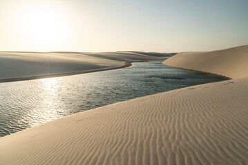 Beautiful view to blue rainwater lagoon on white sand dunes