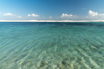 Beautiful view to blue rainwater lagoon on white sand dunes