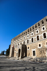 Obraz premium facade of majestic and well preserved Roman theatre in ancient city Aspendos, Turkey under blue spring sky