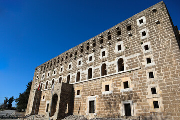 Fototapeta premium facade of majestic and well preserved Roman theatre in ancient city Aspendos, Turkey under blue spring sky