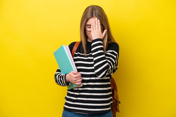 Young student woman isolated on yellow background background with tired and sick expression
