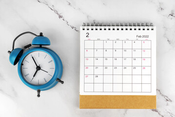 Fototapeta na wymiar February 2022 Desk Calendar With Alarm Clock