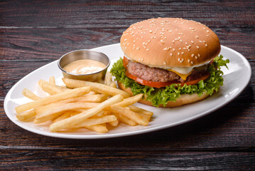 Close-up of home made tasty burger on a dark table