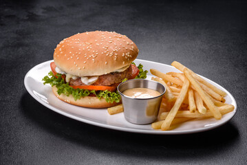Close-up of home made tasty burger on a dark table