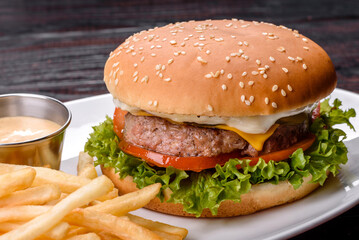 Close-up of home made tasty burger on a dark table