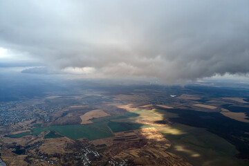 Aerial view from high altitude of earth covered with puffy rainy clouds forming before rainstorm