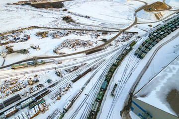 Aerial view of cargo train loaded with crushed stone materials at mining factory. Railway...