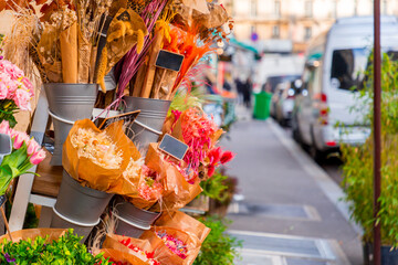 Beautiful flower bouquets and blurry cityscape view in a street in Paris