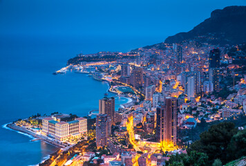 Plakat Aerial view of Monaco - Monte-Carlo at dusk, cityscape with night illumination, mountain, skyscrapers, mediterranean sea