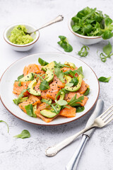 Fresh salmon salad with avocado,  for keto and low carb diet. Rusty background, top view, copy space.