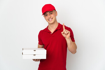 Pizza delivery man with work uniform picking up pizza boxes isolated on white background showing...