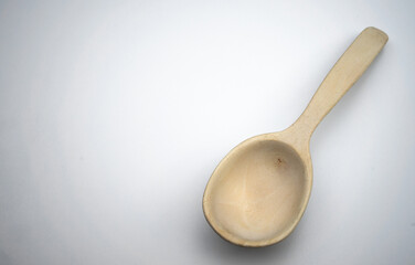 Wooden spoon with your own hands .Wood products. White background for the text. Craft.