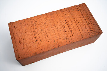 A large red brick on a white background. Sale of bricks. Construction.