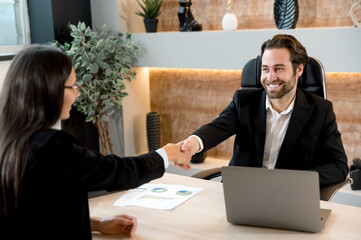 Successful young adult caucasian business colleagues, entrepreneurs, directors, sit at a desktop in...