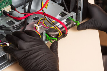Wizard repairs personal computer with tools and hands. Disassembly of the computer into spare parts