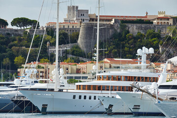 Monaco, Monte-Carlo, a lot of large motor yachts are parked side by side in the port, with huge...