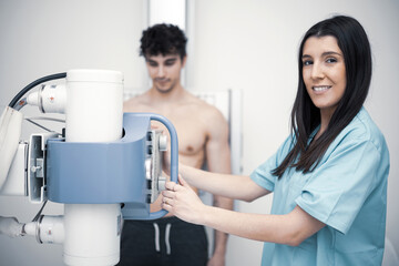 A portrait of a radiologist girl taking an x-ray of a man.