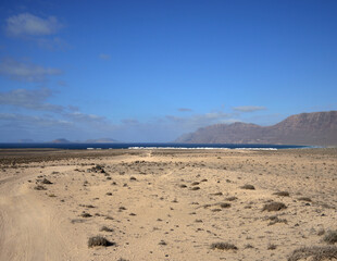 Landscape of Lanzarote, Caleta of Famara, island of La Graciosa and intense blue sky, Canary Islands, Spain
