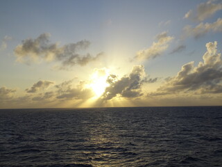 Sunset over ocean with blue sky