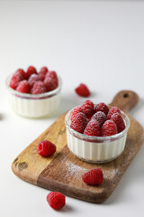 Italian dessert panna cotta with raspberries on white background.