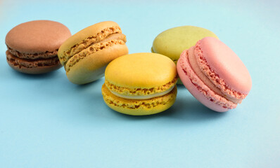 Macaroons, isolated on blue background, typical french sweet.