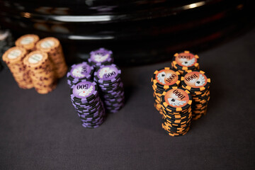 Multicolored casino table with roulette in motion, with multicolored casino chips. multi-colored...