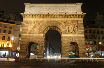Paris, the porte Saint-Martin, beautiful ancient gate near the Grands Boulevards at night.