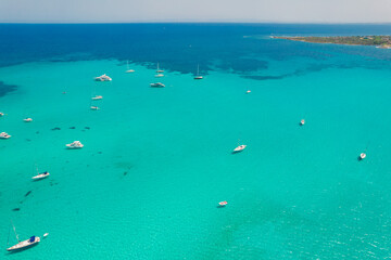 Aerial view of many yachts and sailboats in turquoise water in Mediterranean Sea