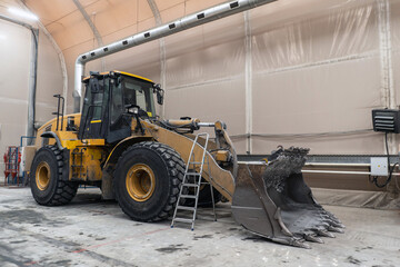 The loader is serviced at the industrial garage.
