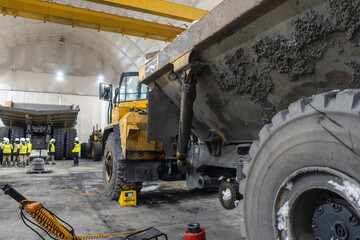 Articulated dump truck is serviced in an industrial garage. © CjVitoS
