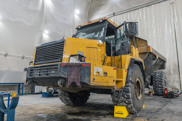 Articulated dump truck in the garage for repairs.